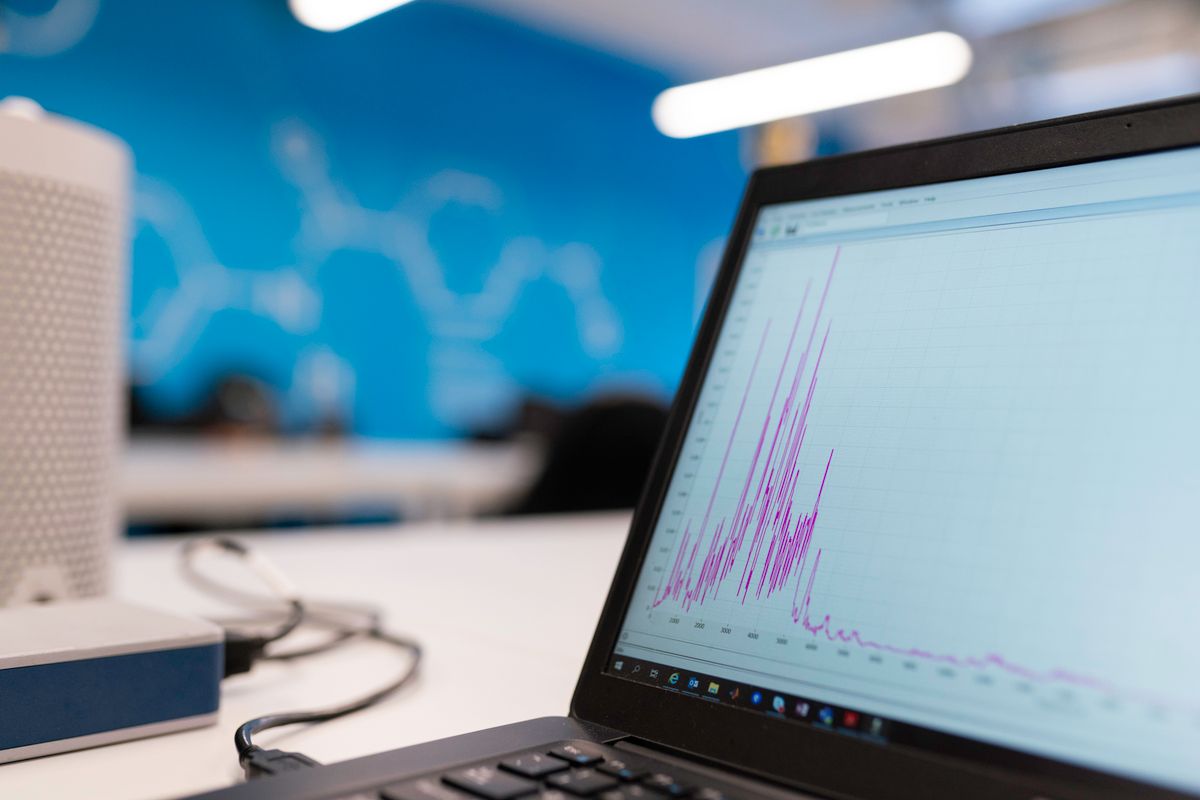Laptop screen showing marketing analytics graphs in a modern office