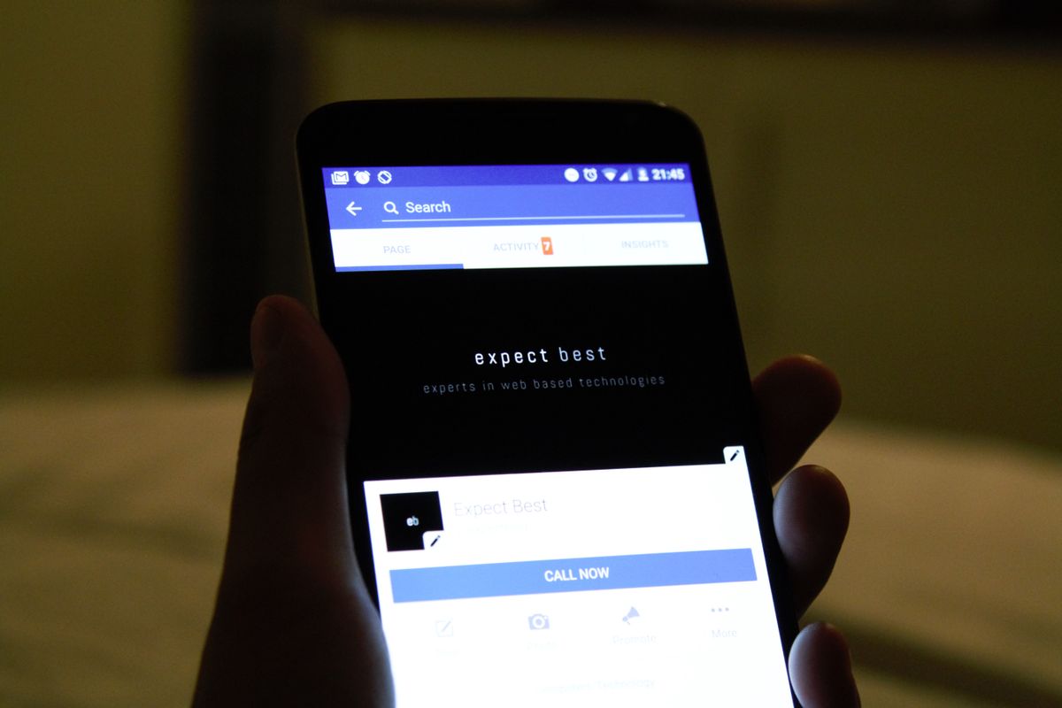 Hand holding a smartphone showing an app