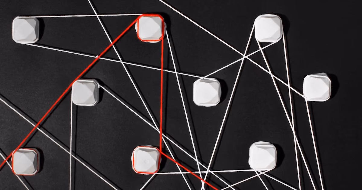 A network of connected elements on a black background entwined by various links with one main defining red line.