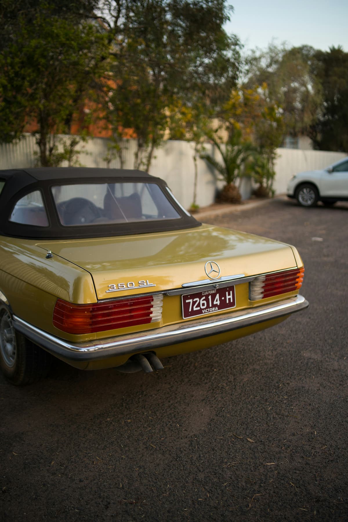 Gold convertible Mercedes 350SL.