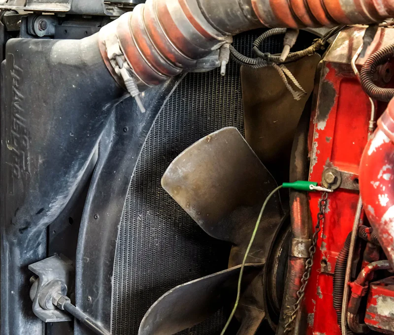 A fan clutch in a semi wth a green electrical connection.