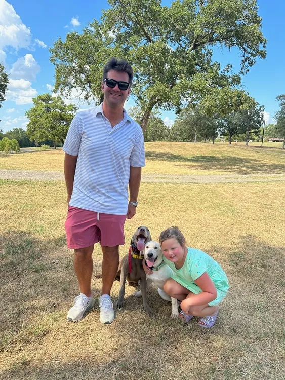 couple posing with dog