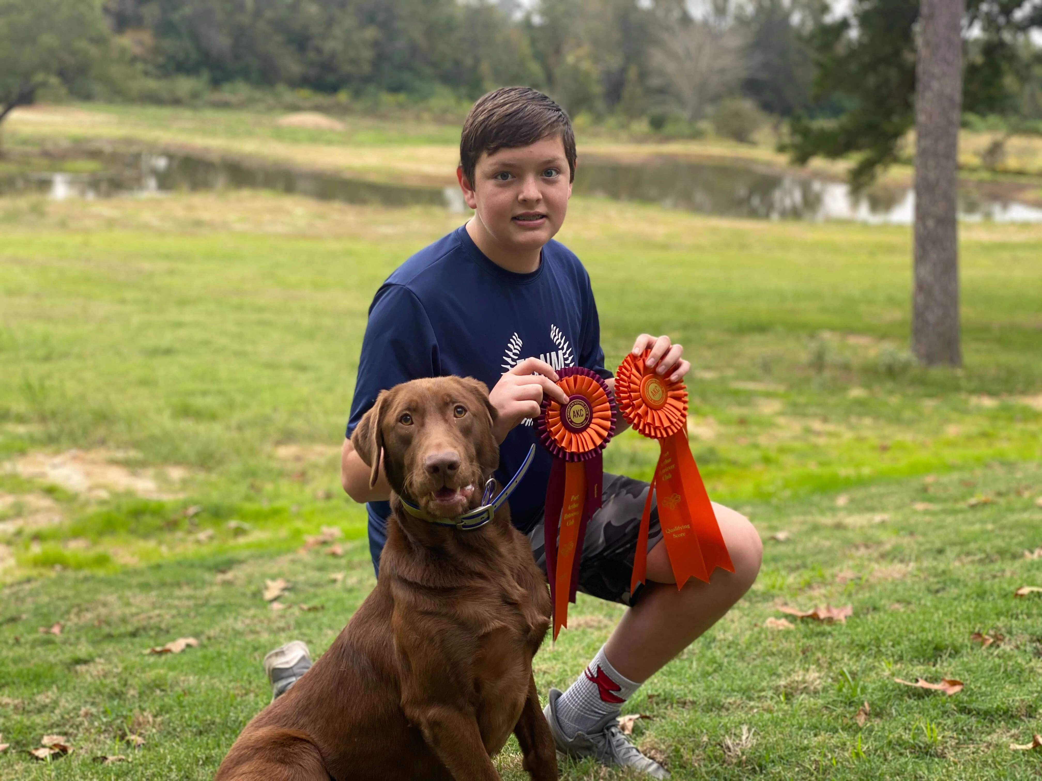 owner with dog and medal for dog training in Longview TX