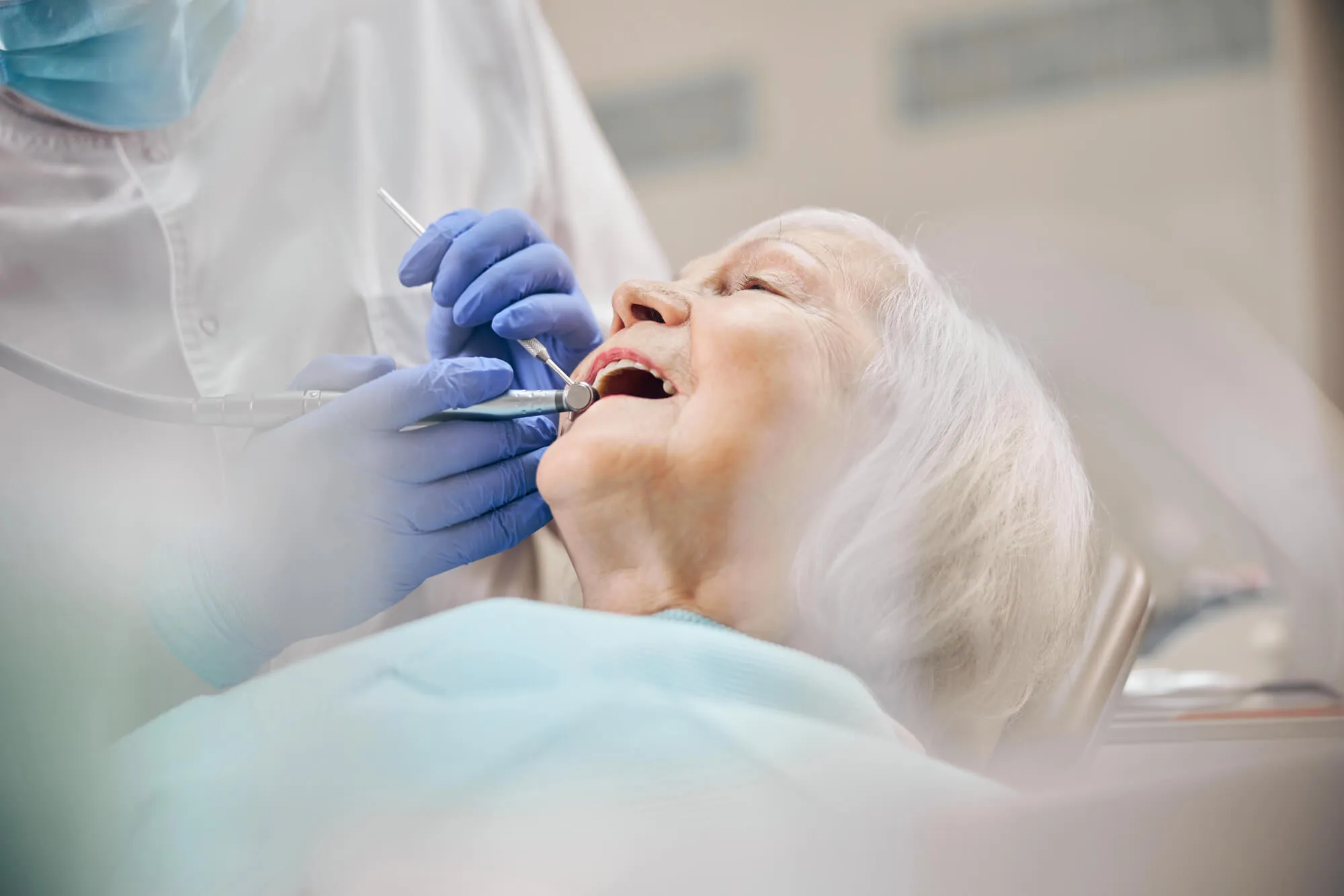 emergency dentist greensboro nc checking patient's teeth
