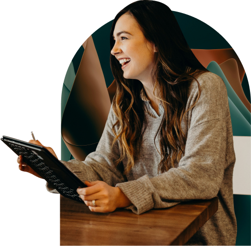 A woman laughing with a tablet