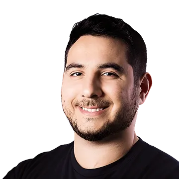 Smiling man with short dark hair and beard wearing a black shirt against a transparent background.
