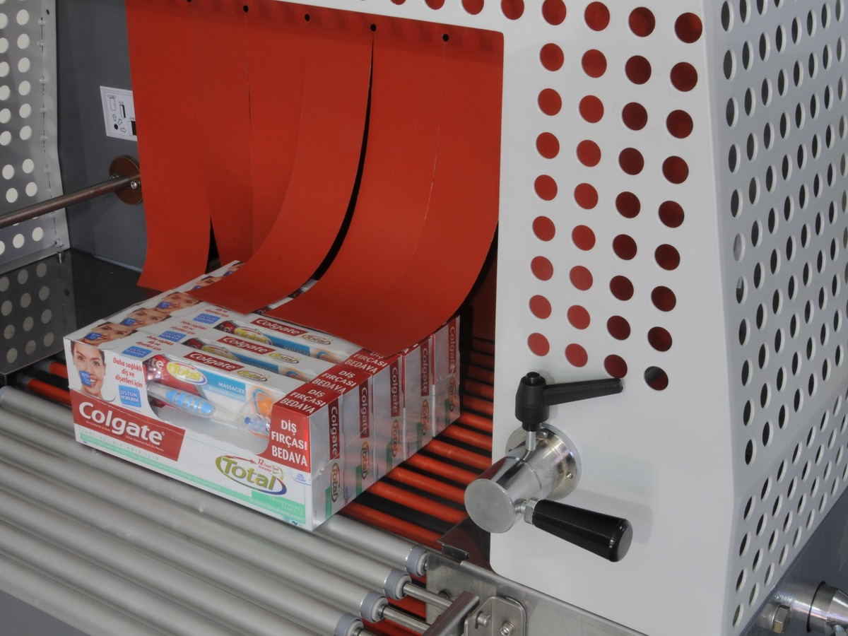 Product passing through an industrial heat shrink tunnel