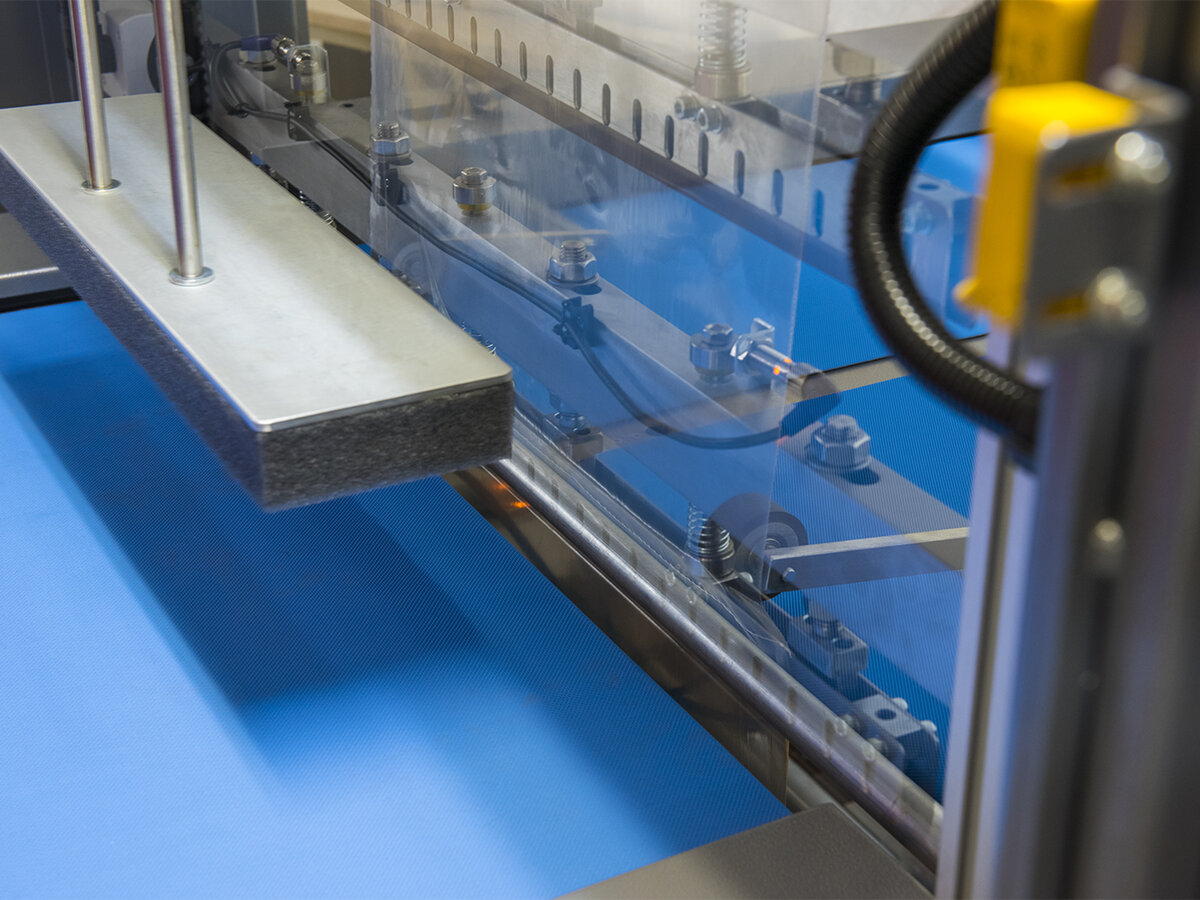 Close-up of a sleeve wrapper sealing bar and conveyor