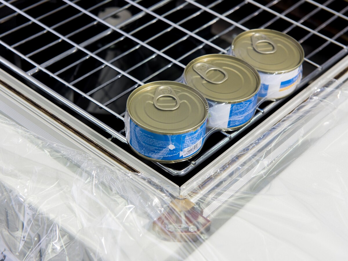 Three cans positioned for chamber shrink wrapping