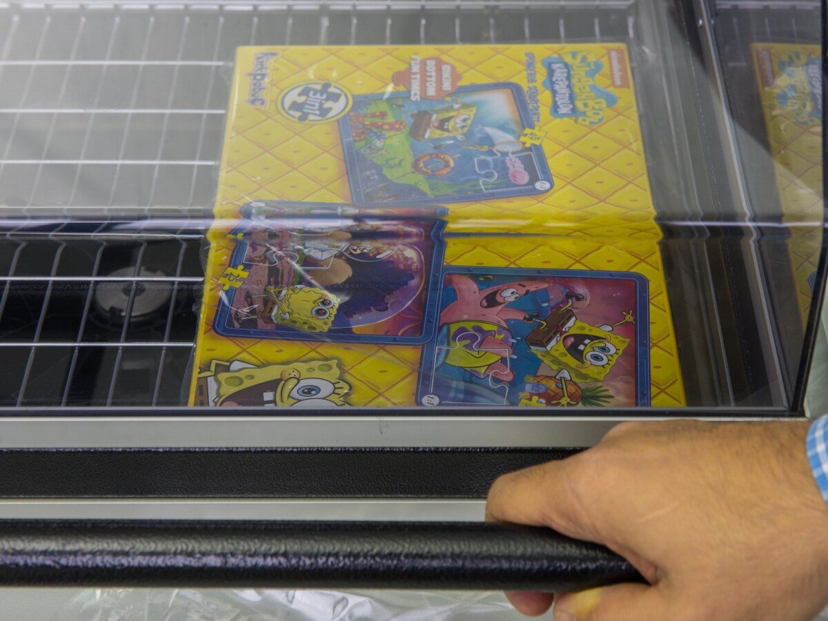 Operator closing the hood to seal and shrink a boxed product