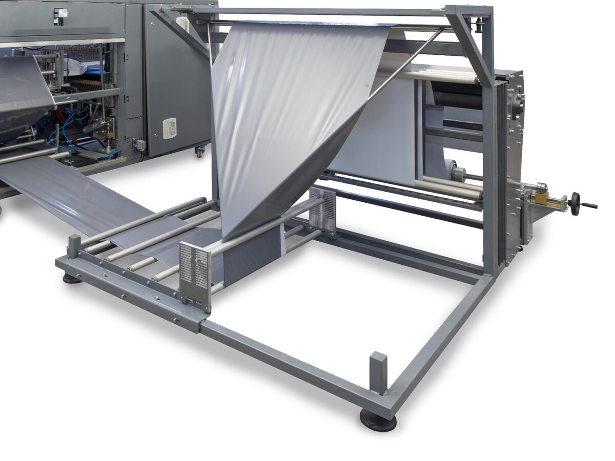 Roll-fed packaging film handling system