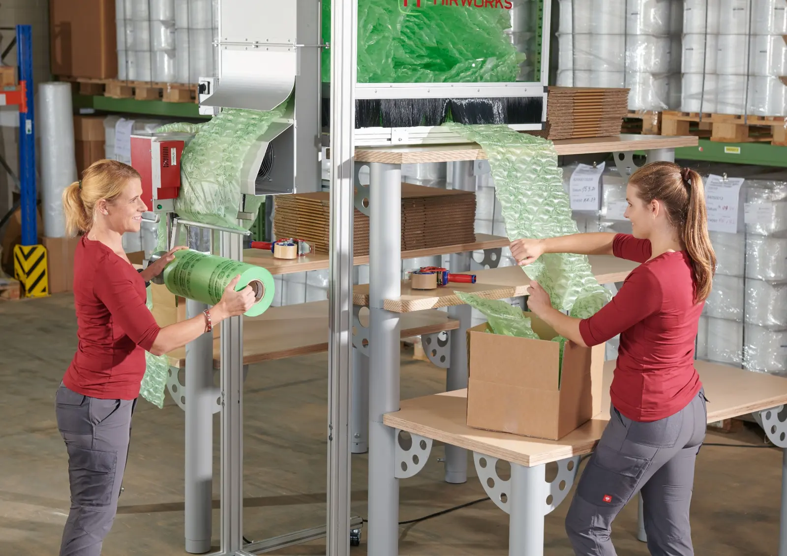 Operators using Cirrus protective air cushioning at integrated packing workstations