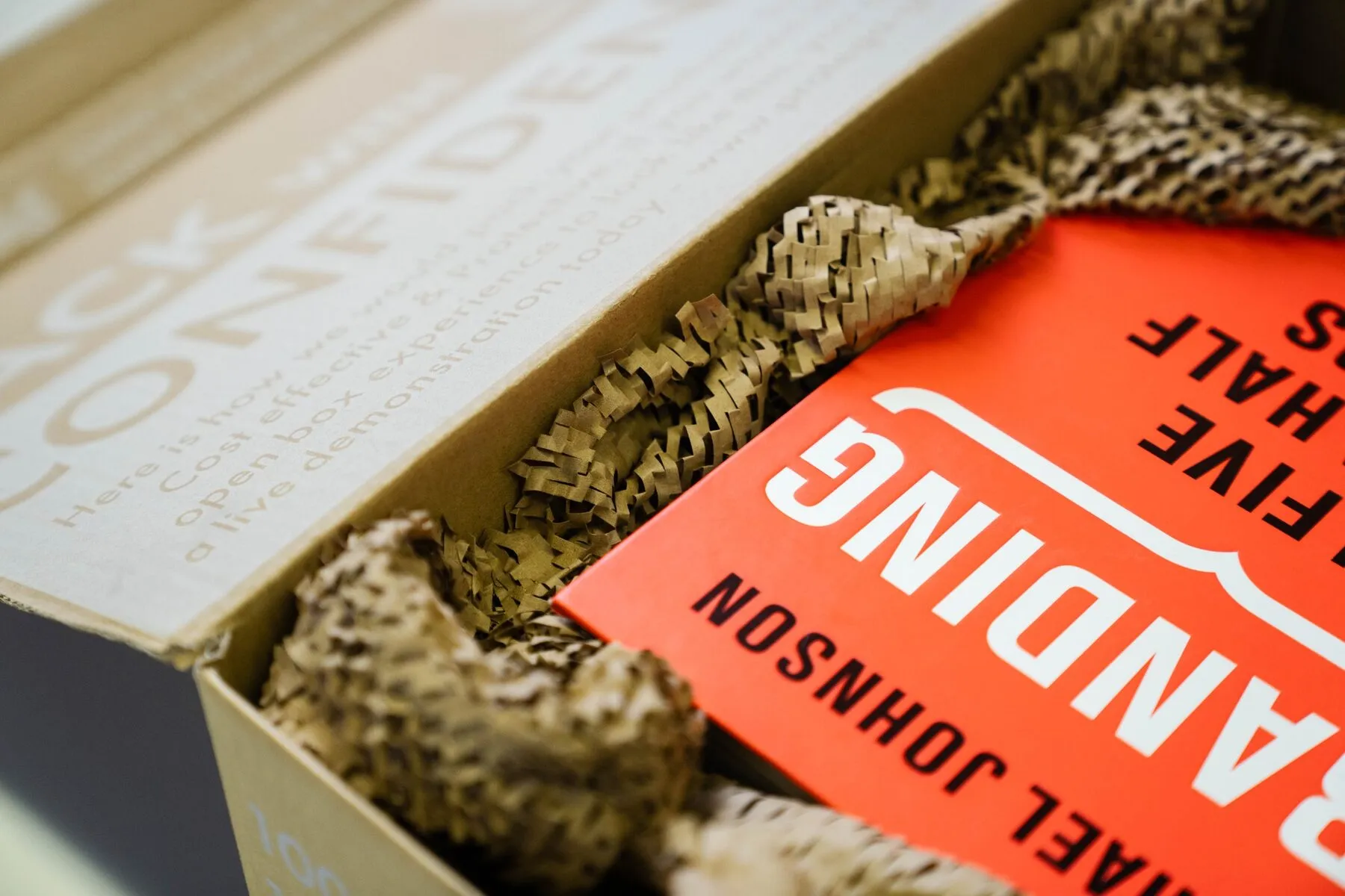 Carton protected with expanded recyclable paper void fill