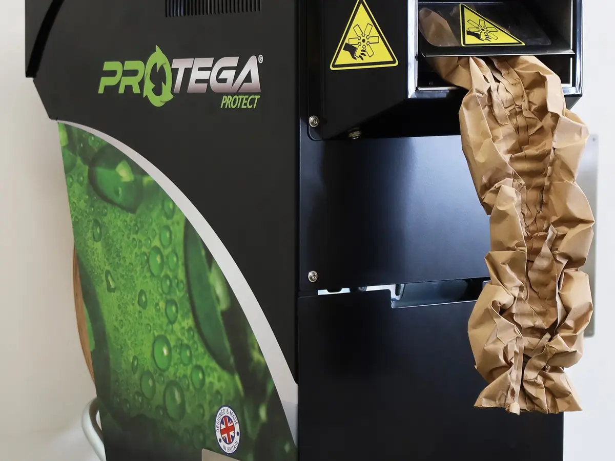 Paper cushioning machine producing a structured recycled paper cushion