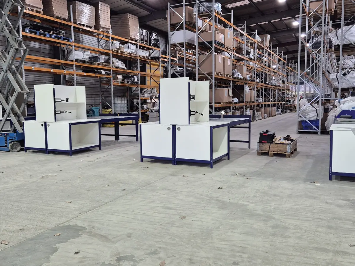 Multiple modular pack benches installed across a warehouse operation