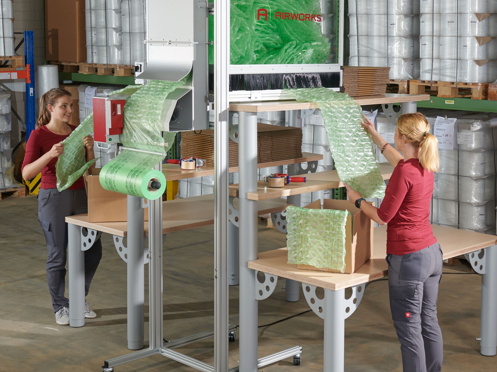 Cirrus Station overhead pneumatic duct and storage delivering air cushions directly to an integrated packing bench