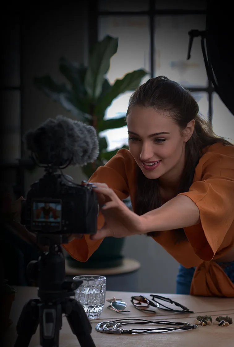 young woman setting up video camera for filming herself