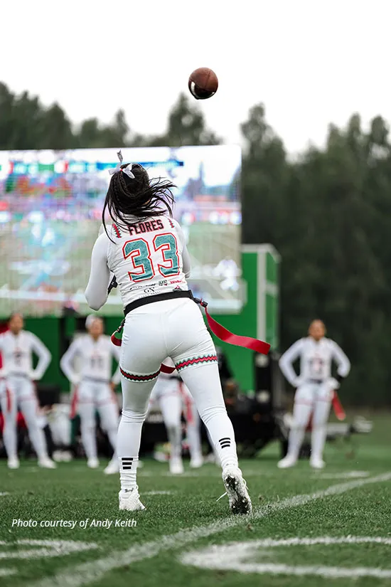 Author Diana Flores throws the ball in a game playing for her Team Mexico