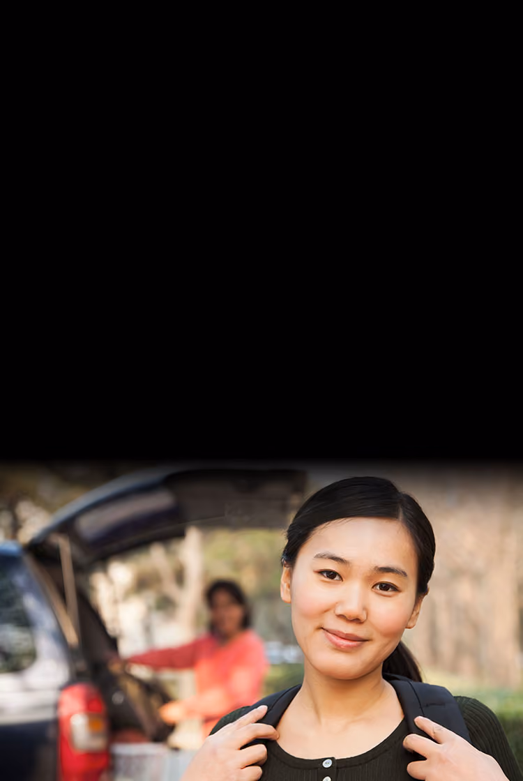 young woman getting ready to head to college as mom loads car.