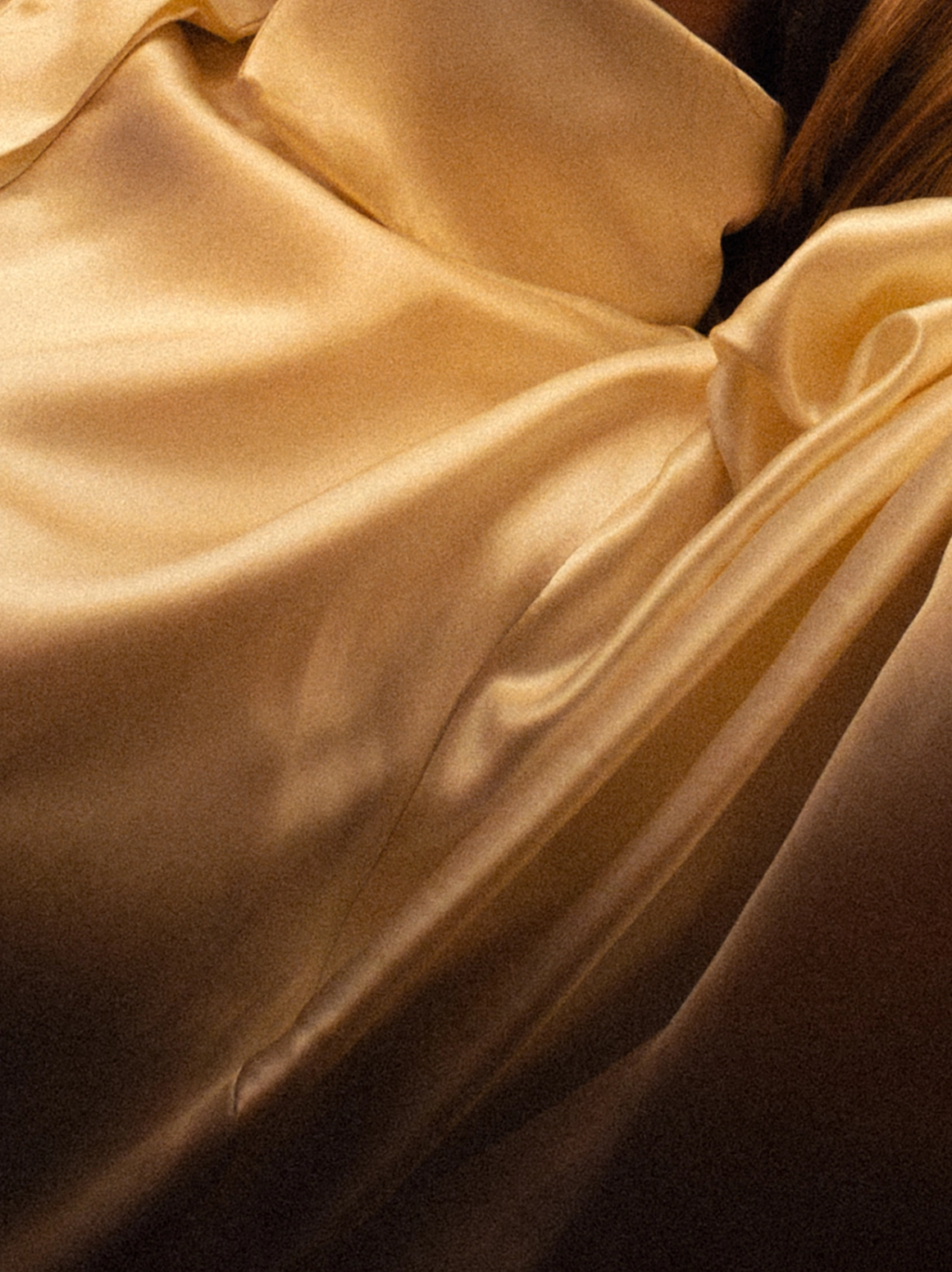 Close up collar and shoulder of a hand-sewn ivory silk blouse.