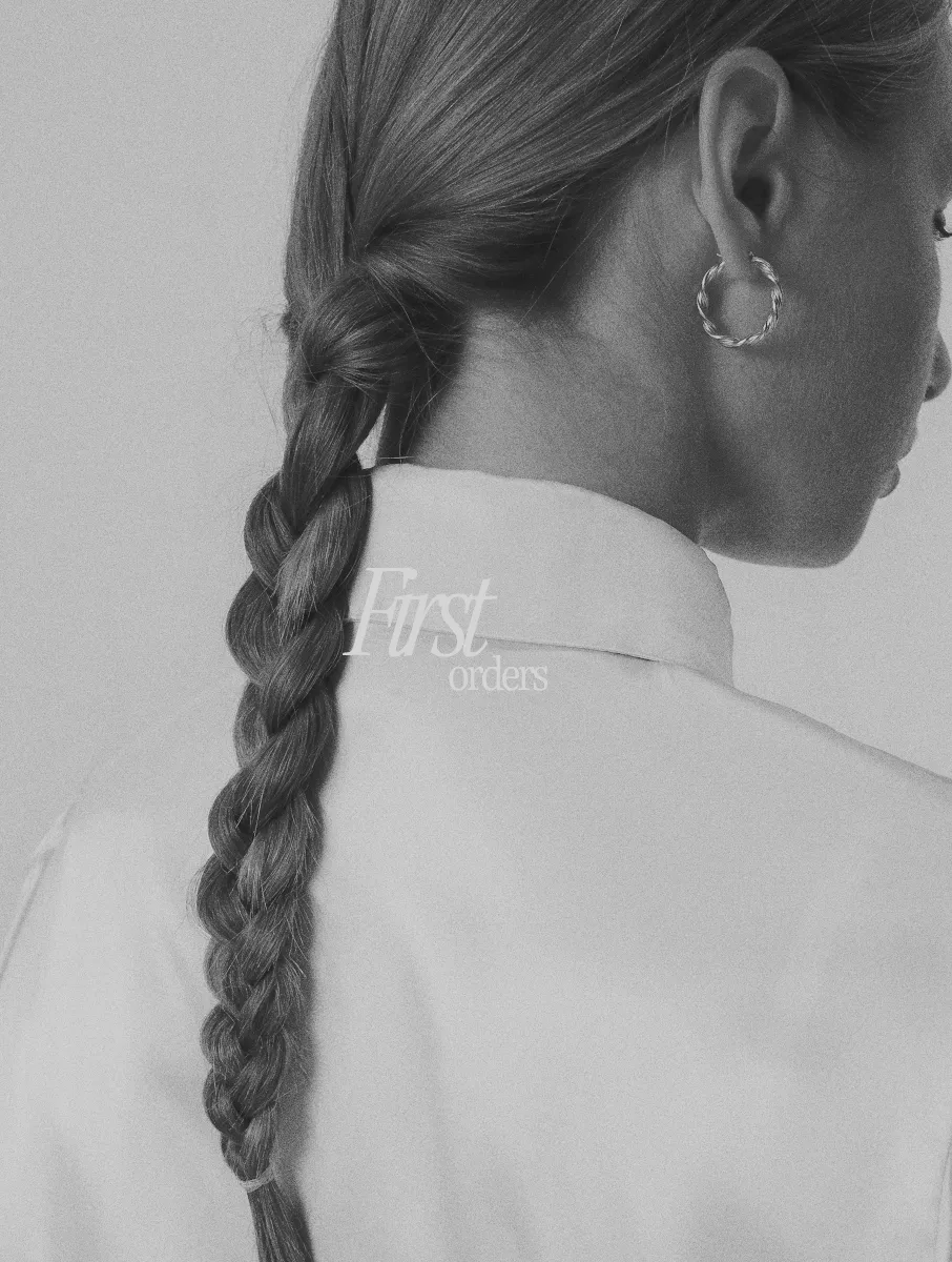 a image of a women with a plat hair style wearing a silk blouse