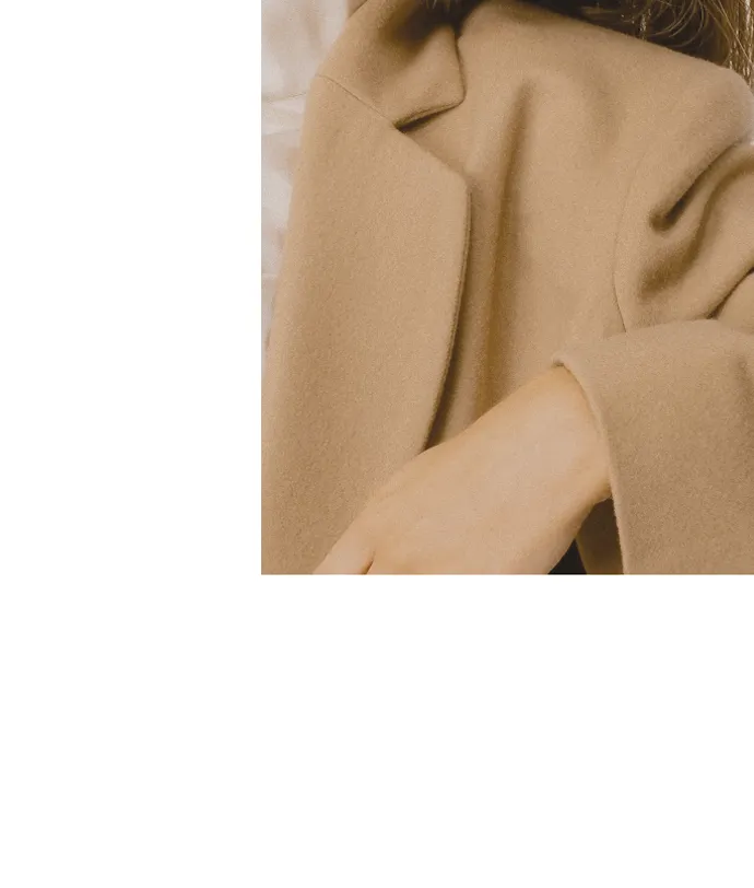 Shoulder detail of a wool camel womens coat by Lutea Studios.