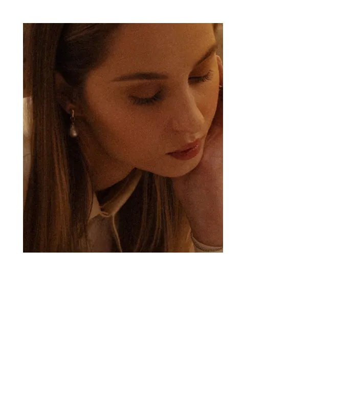 A close up portrait of a women reading a book in a silk blouse.