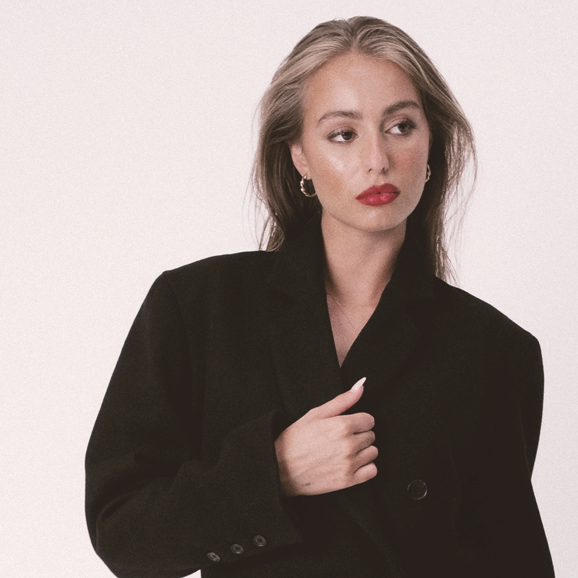 A women wearing the cameley wool coat by Lutea studios, somerset