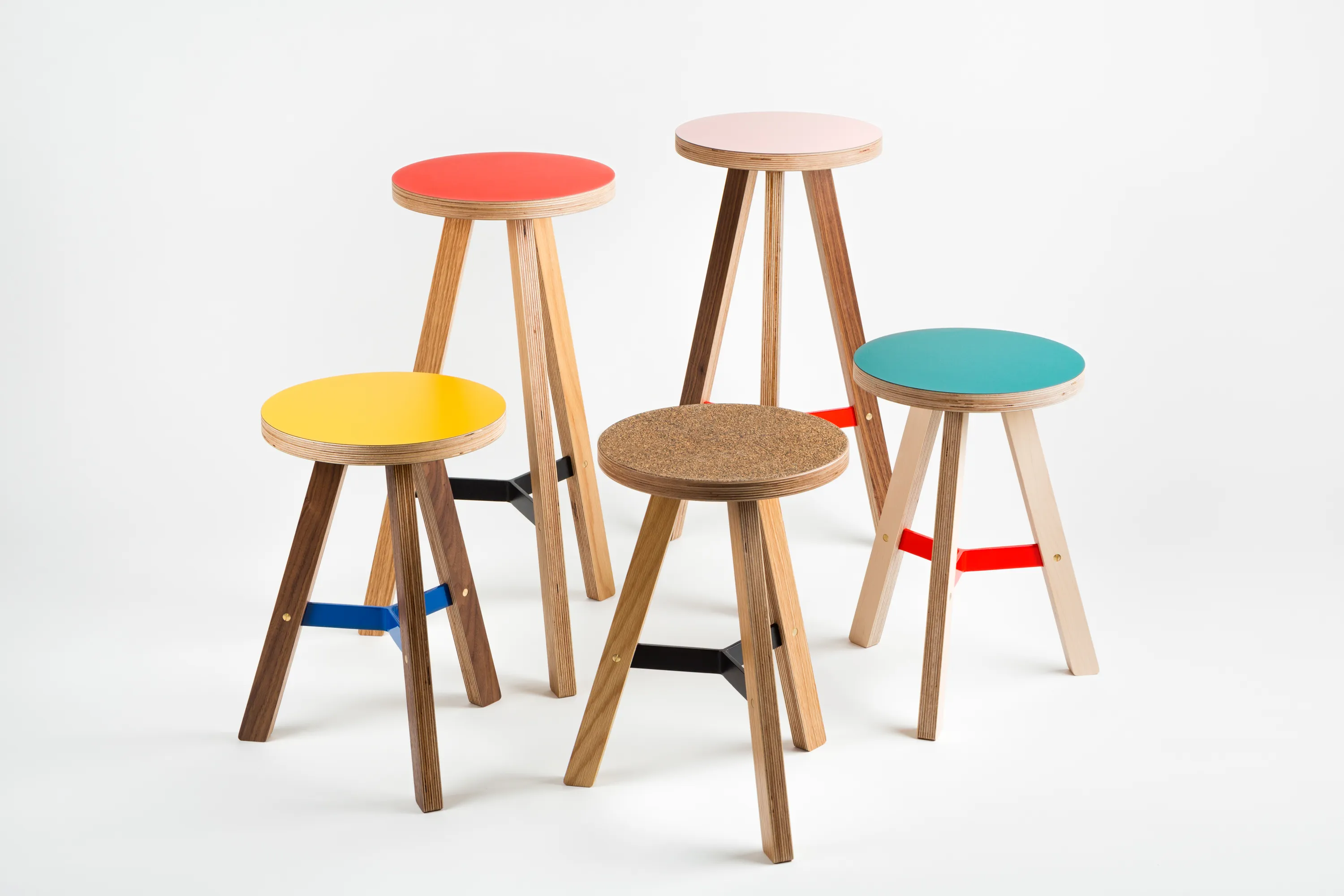 Uncommon Object high stools and low stools in oak, walnut and maple veneer with colourful seats. 