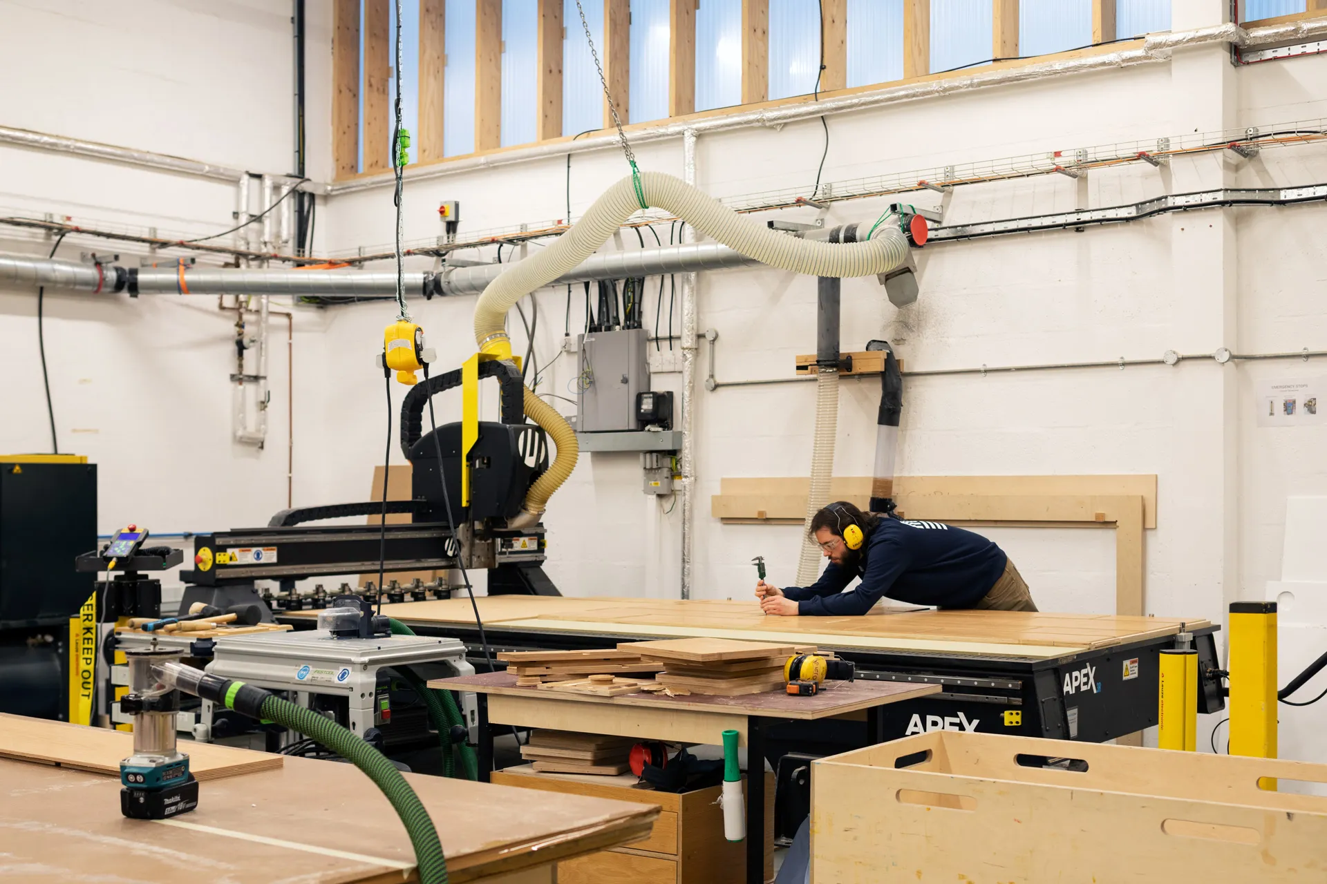 Uncommon Projects workshop crafting bespoke birch plywood cabinetry using CNC machinery