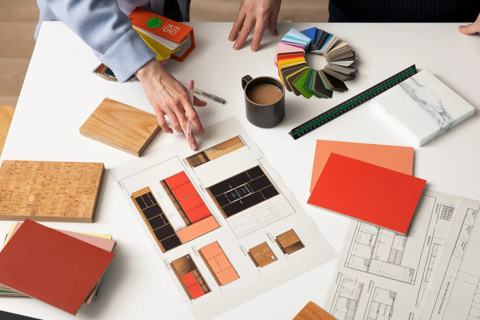 Kitchen design consultation at Uncommon Projects with plywood samples, colour swatches and cabinetry drawings