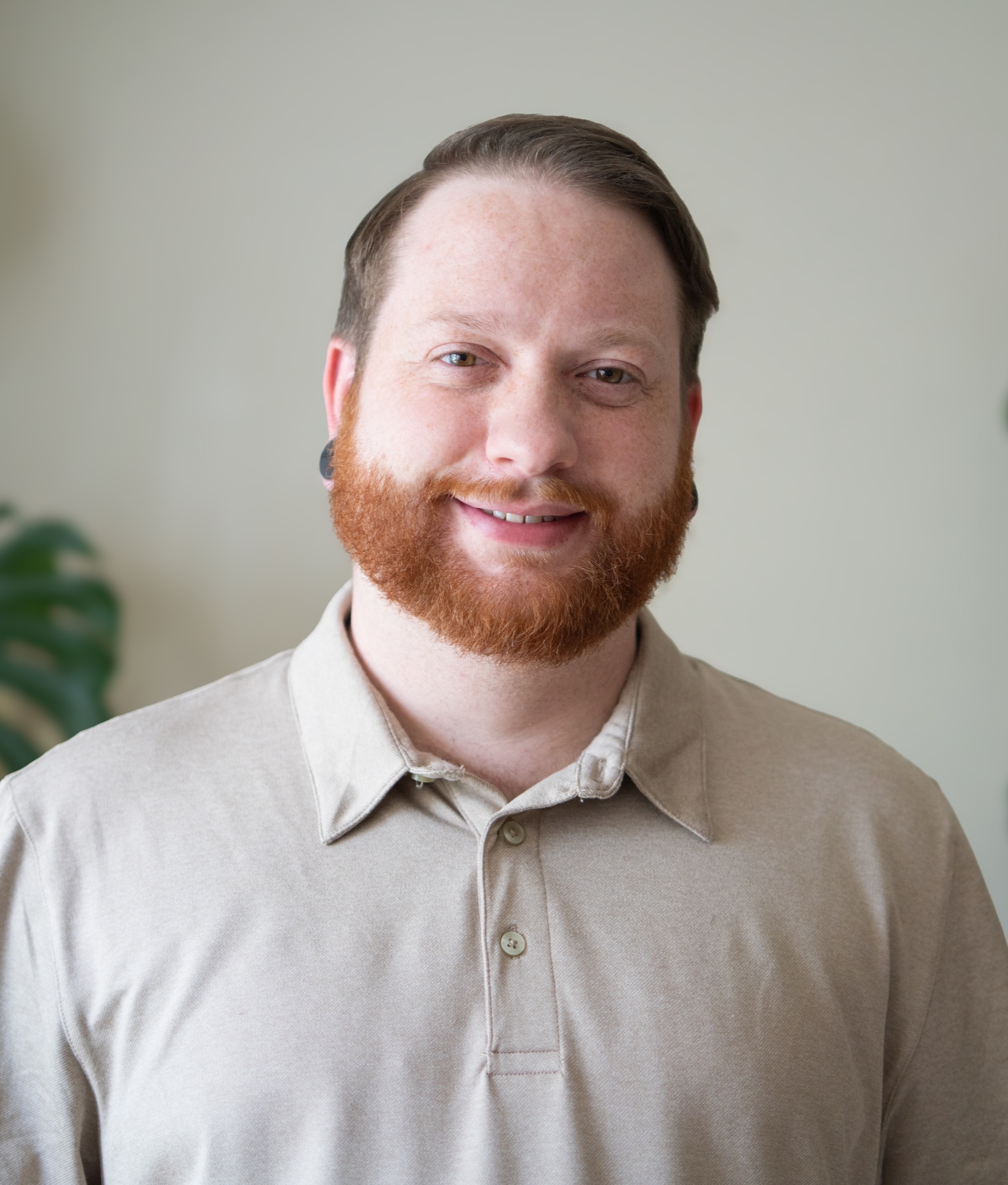 Portrait of Limn team member Josh Owen seated on a sofa