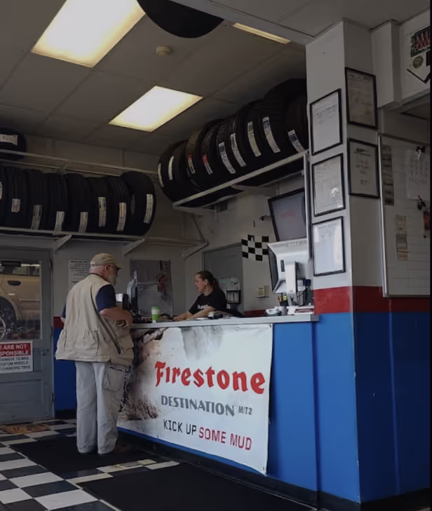 H&F Tire Service employee helping a client