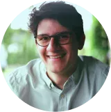 A man with glasses is smiling for a picture.