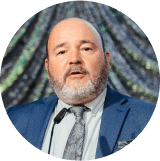 A man with a beard wearing a suit and tie.