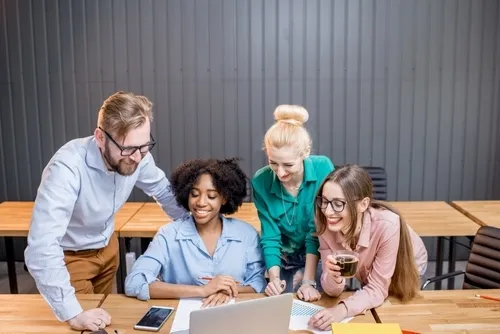 Teamwork looking at a laptop