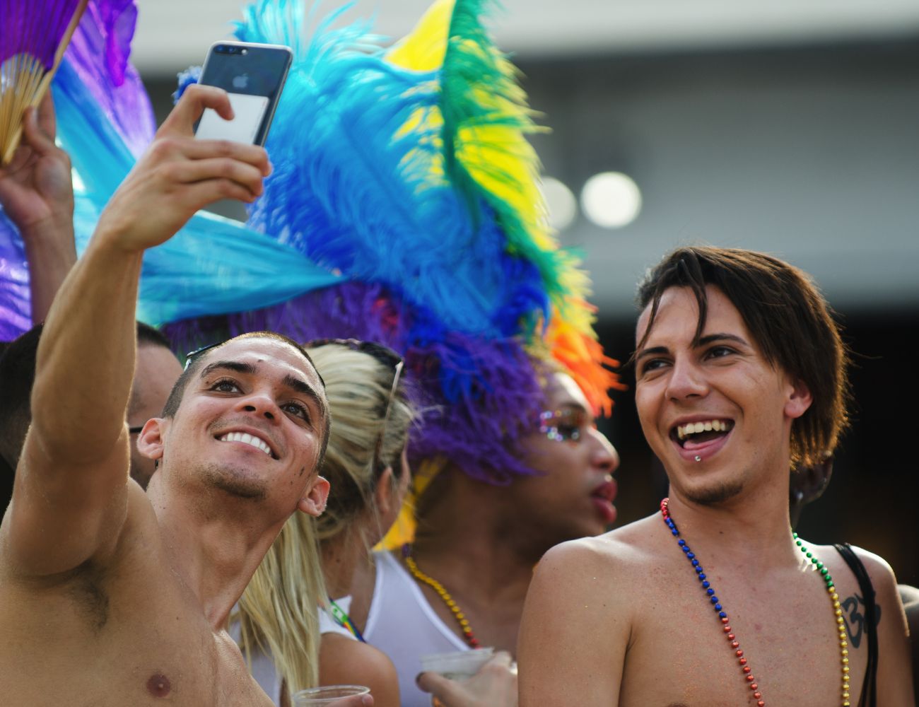 people celebrate pride month during a festive parade