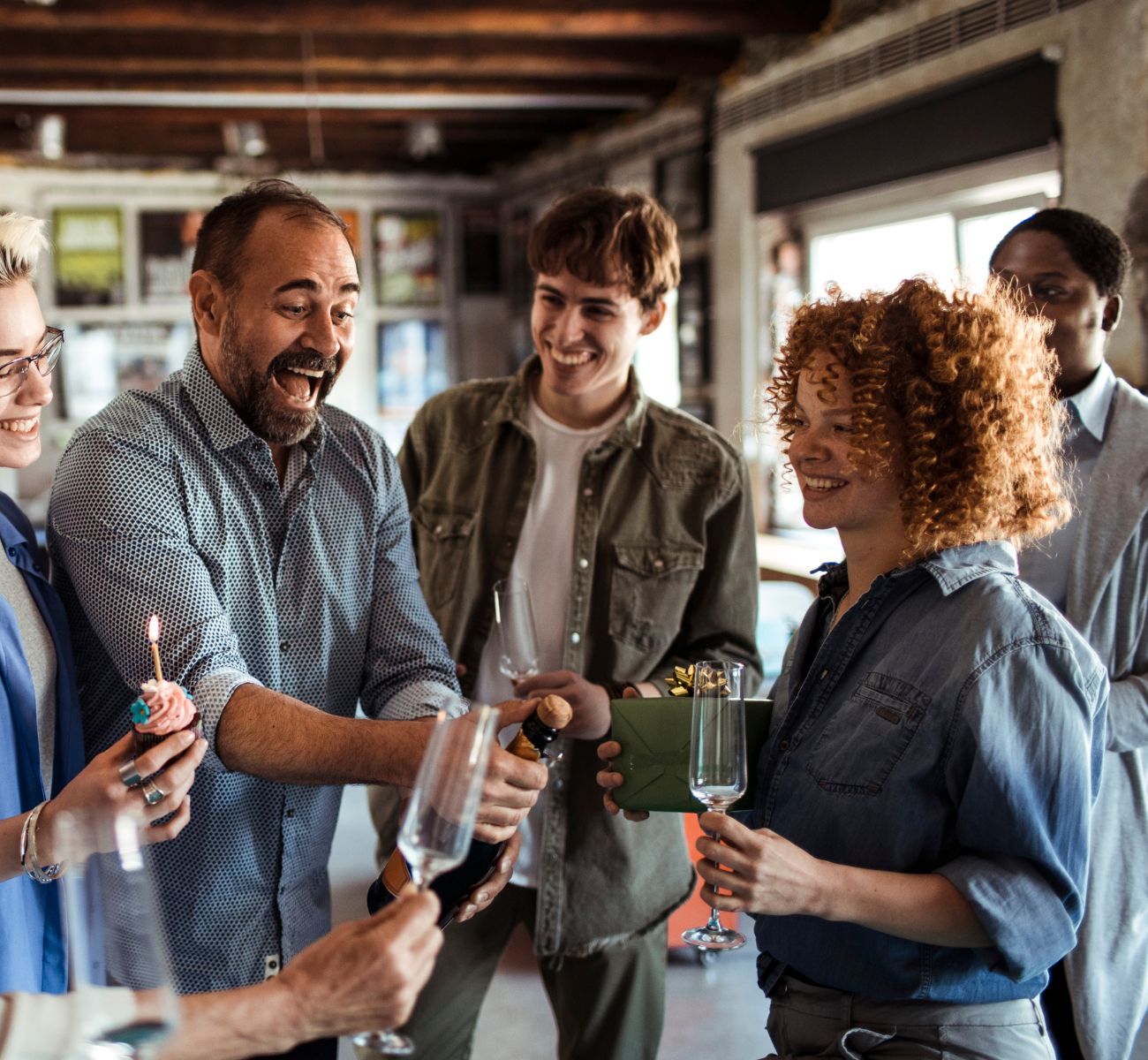 Close up of a group of coworkers having a celebration in their office