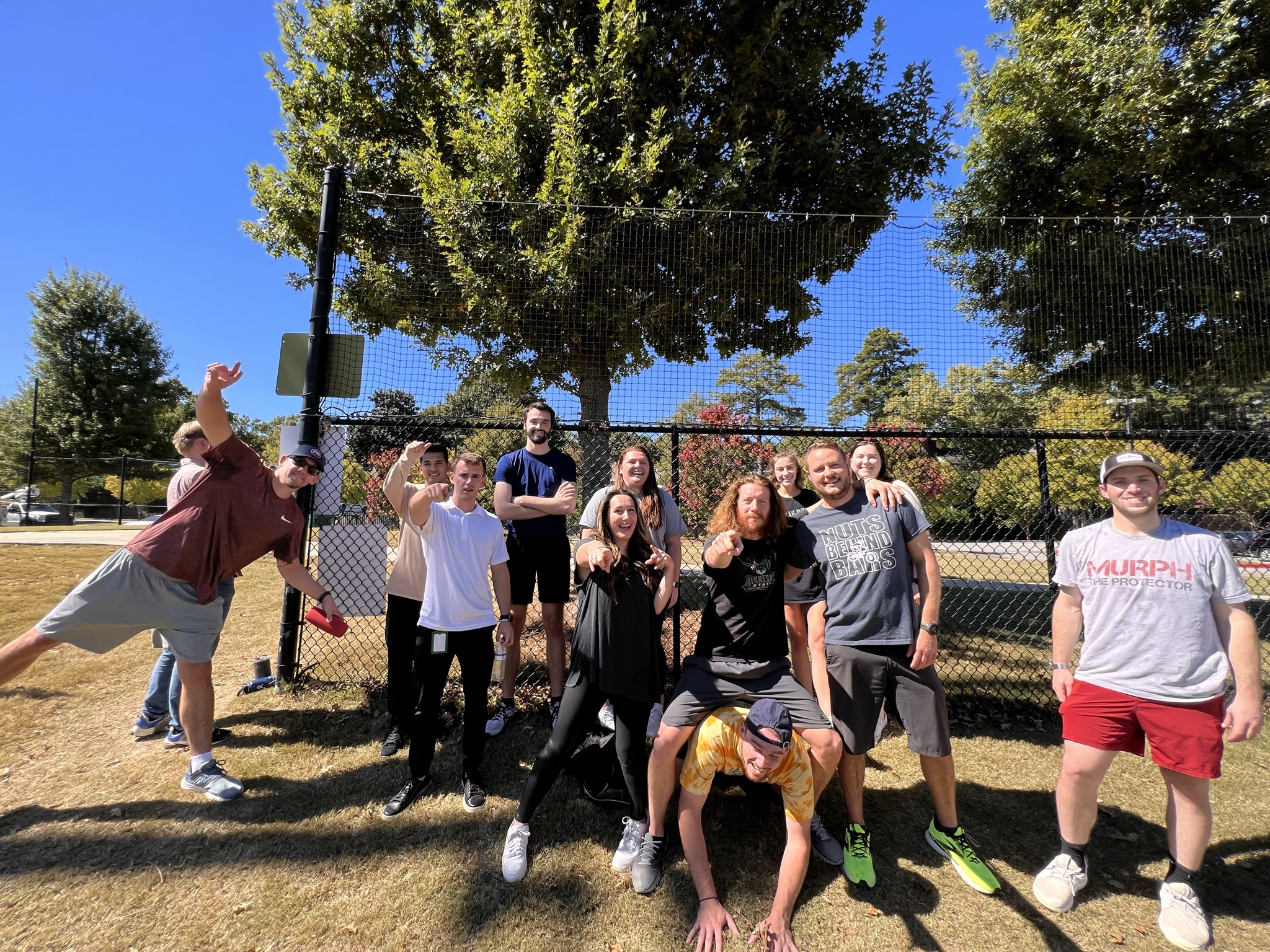 Team of coworkers enjoy team outing at a park. Featured in article "10 quotes about employee engagement"