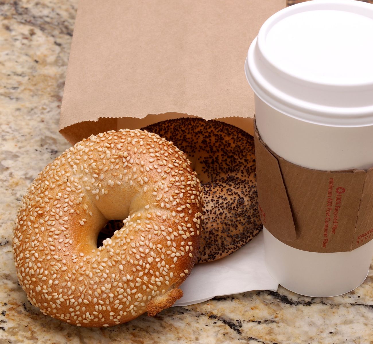 a bagel and cup of coffee on a table