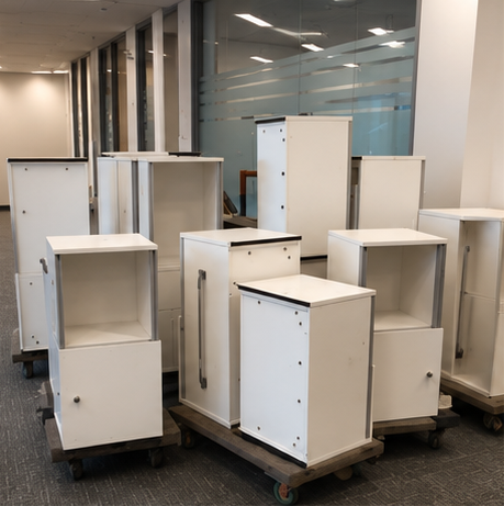 White mobile office pedestals staged on dollies during a Toronto office decommission