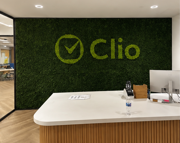 Green moss feature wall behind a reception desk in a Toronto office