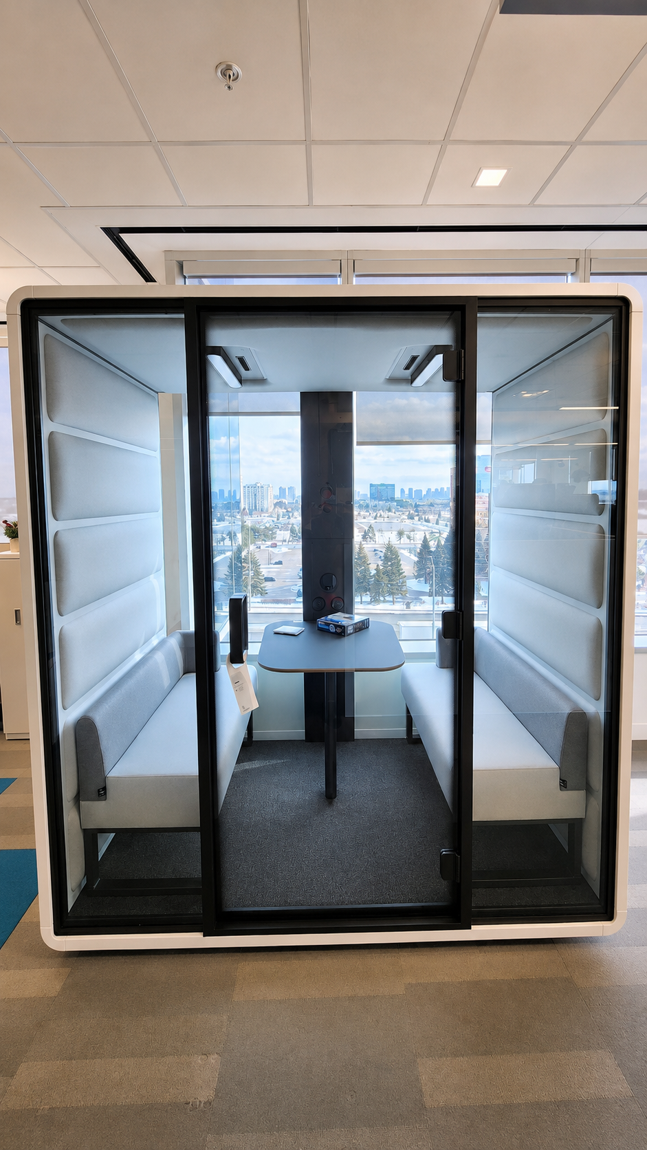Freestanding acoustic meeting pod with city views in a Toronto office