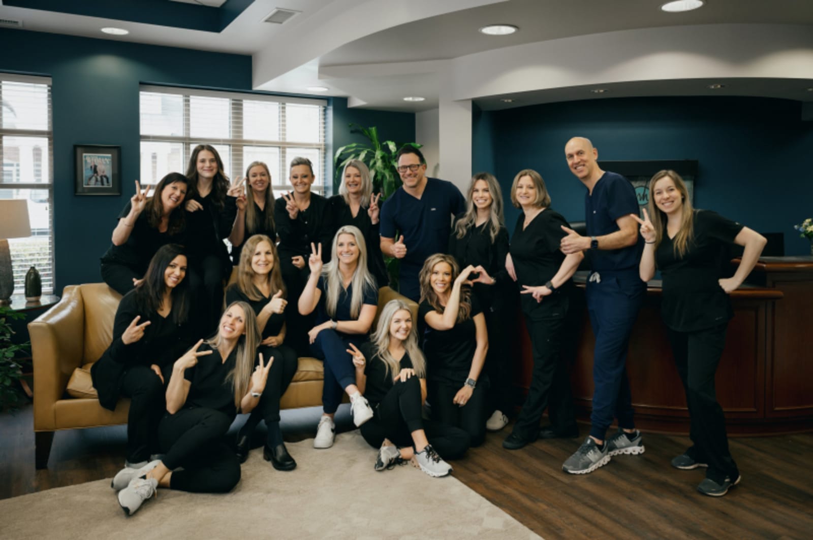 White and Haines dental team posing together in modern office setting