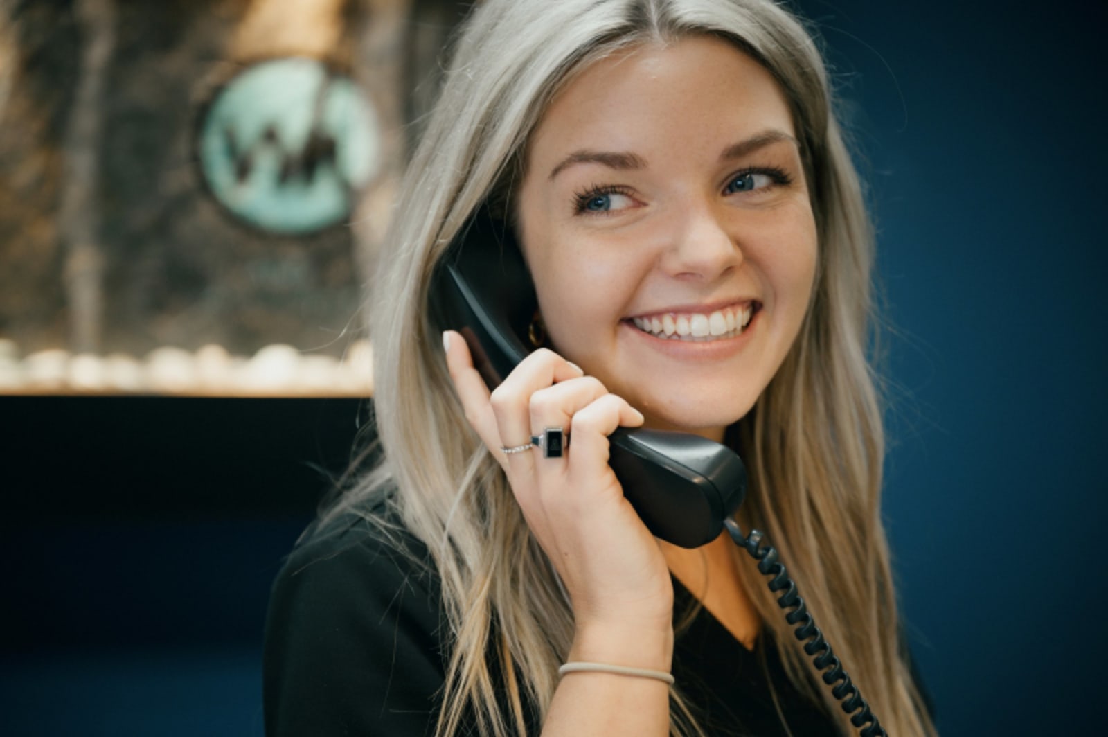 Woman on phone smiling, representing patient communication and consultation