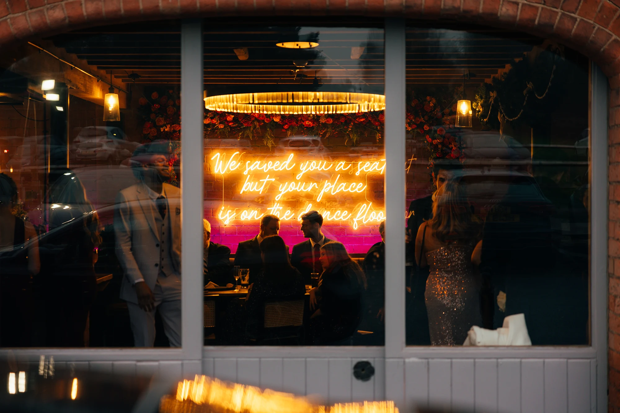 Guests inside the Gallery Bar seen through the windows at Blackbrook Barns, Lichfield, Staffordshire