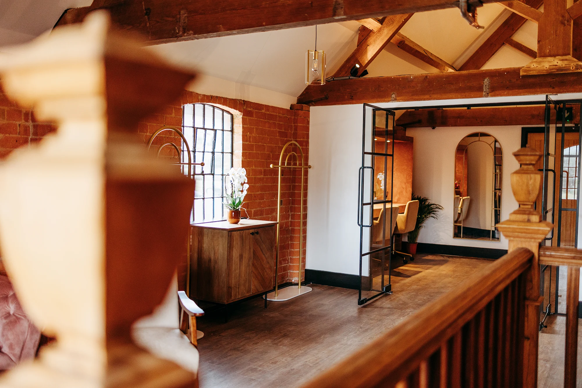 Upstairs prep room landing with arched window and dressing area at Blackbrook Barns, Lichfield, Staffordshire