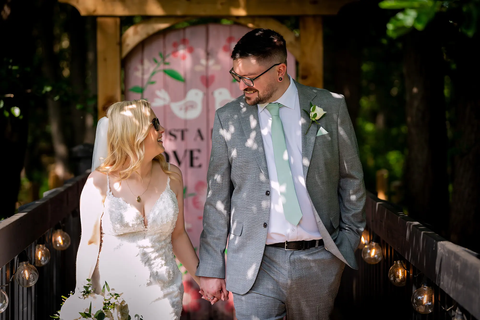 Newlyweds on the woodland bridge with confetti at Blackbrook Barns, Lichfield, Staffordshire