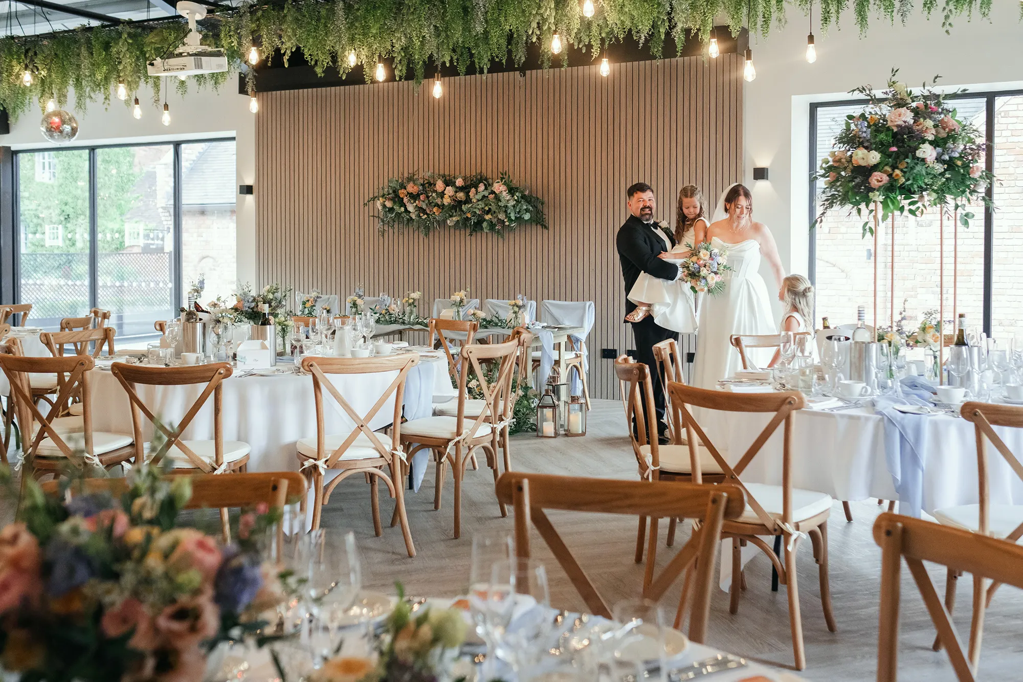 Newlyweds in The Cow Shed set with pastel florals at Blackbrook Barns, Lichfield, Staffordshire