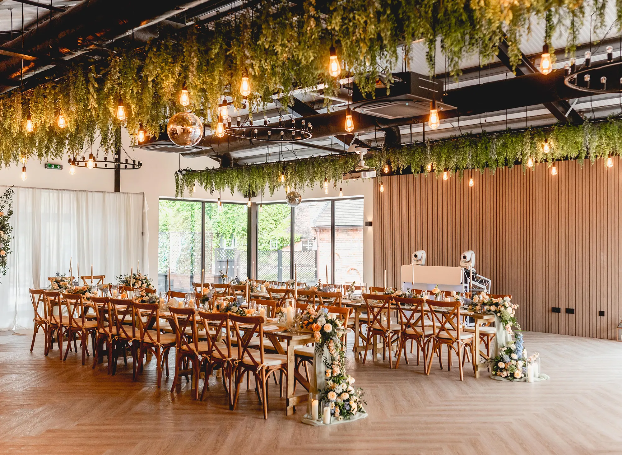 The Cow Shed set with long banquet tables and a cake table at Blackbrook Barns, Lichfield, Staffordshire